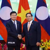 Thủ tướng Phạm Minh Chính hội kiến Tổng Bí thư, Chủ tịch nước Lào Thongloun Sisoulith. (Ảnh: Dương Giang/TTXVN)