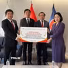 Bộ trưởng Bộ trưởng Bộ Khoa học và Công nghệ Vũ Hải Quân chứng kiến Giám đốc Học viện Công nghệ Bưu chính Viễn thông Đặng Hoài Bắc trao Ứng dụng học tiếng Việt tới Lãnh đạo Đại sứ quán Việt Nam tại Hàn Quốc. (Ảnh: Đào Lâm/TTXVN)
