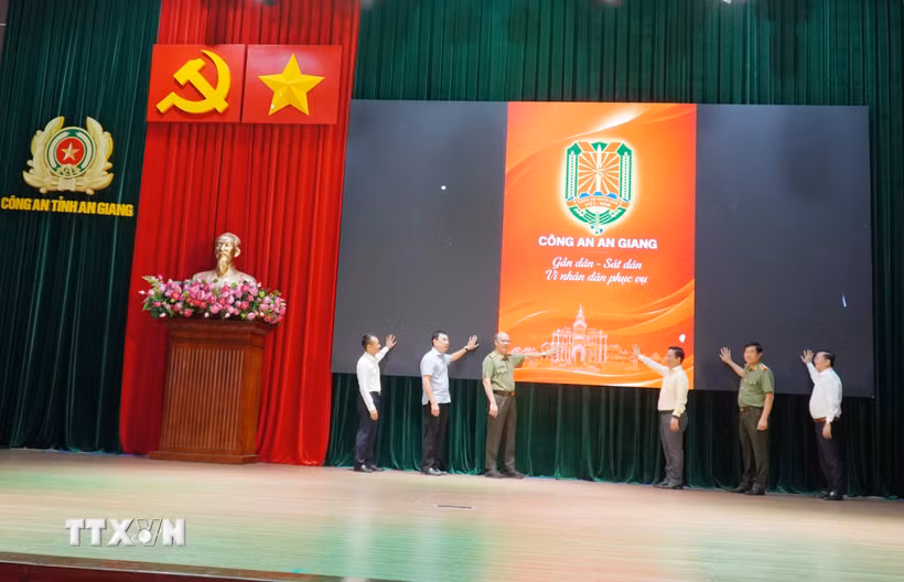 Các đại biểu thực hiện nghi thức ra mắt Ứng dụng (App) “Công an An Giangn gần dân, sát dân, vì nhân dân phục vụ”. (Ảnh: Văn Sĩ/TTXVN)