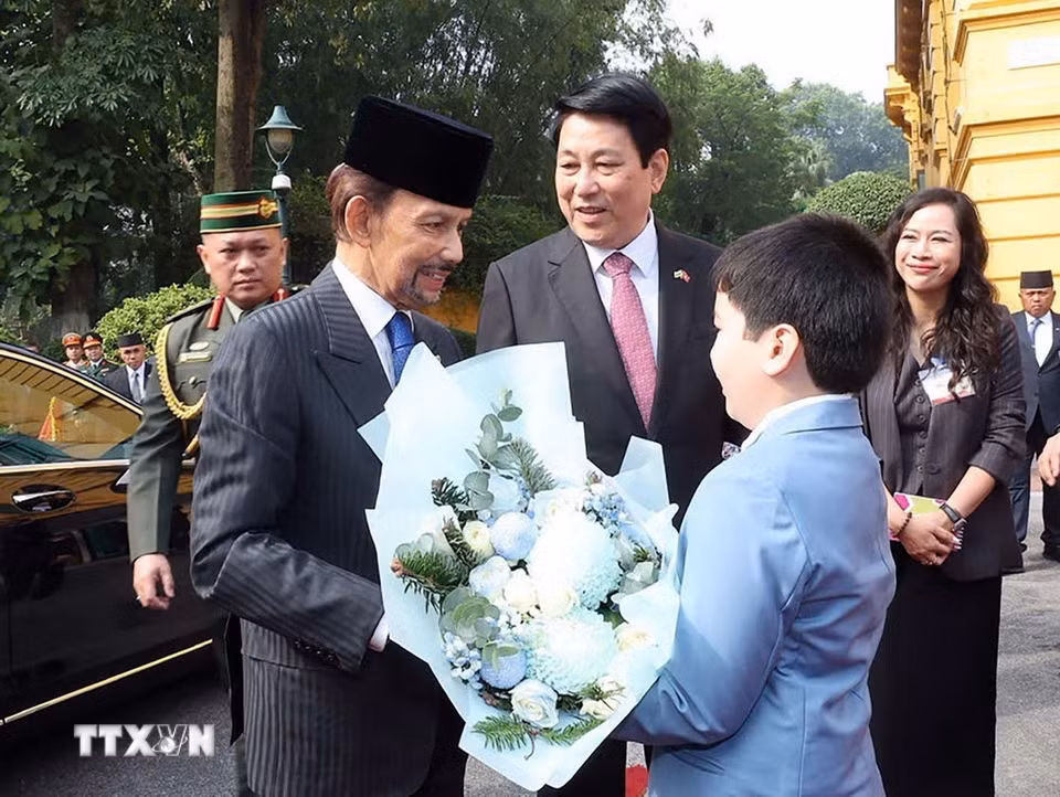 Thiếu nhi Thủ đô Hà Nội tặng hoa Quốc vương Brunei Darussalam Haji Hassanal Bolkiah tại lễ đón. (Ảnh: Lâm Khánh/TTXVN)