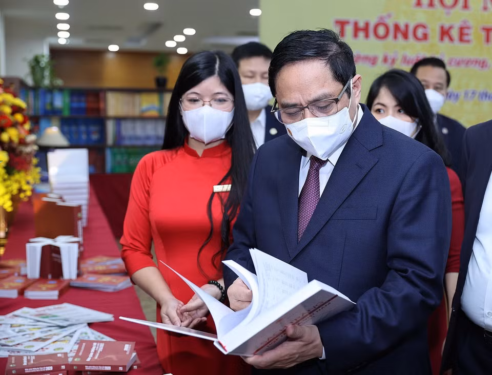  Thủ tướng Phạm Minh Chính xem sách, hình ảnh, hiện vật của ngành thống kê. (Ảnh: Dương Giang/TTXVN)