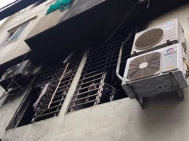 Khói ám đen căn hộ tầng 2 tòa chung cư mini bị cháy. (Ảnh: TTXVN phát)