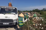 Công nhân Công ty Một thành viên Môi trường đô thị Hà Nội thu dọn rác thải bị đổ trộm tại Đại lộ Thăng Long. (Ảnh: Mạnh Khánh/TTXVN) 