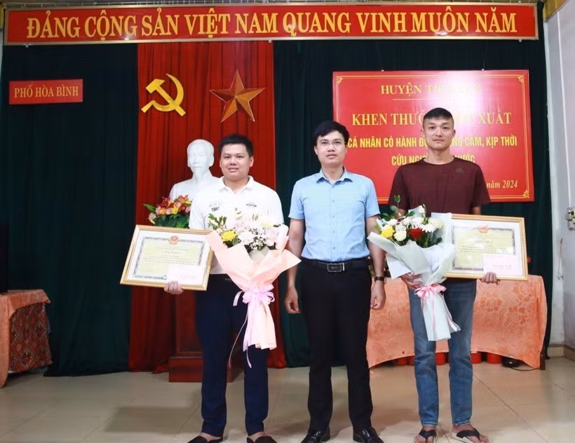 Ủy ban Nhân dân huyện Tiên Yên (Quảng Ninh) biểu dương, khen thưởng đột xuất 2 nam thanh niên dũng cảm cứu người. (Ảnh: TTXVN phát)