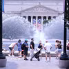 Du khách tránh nắng nóng bên đài phun nước tại khu vực National Mall (Quảng trường Quốc gia) ở thủ đô Washington D.C. (Ảnh: Ngọc Quang/TTXVN)