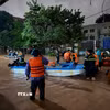 Lực lượng chức năng dùng thuyền di dời các hộ dân về nơi an toàn. (Ảnh: Tiến Vĩnh/TTXVN)
