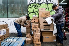 Công nhân bốc dỡ hàng hóa tại một cửa hàng ở New York, Mỹ. (Ảnh: THX/TTXVN)