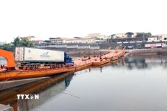 Các phương tiện được thông quan và chở hàng hóa qua lối mở cầu phao Km3+4 Hải Yên. (Ảnh: Vi Thu/TTXVN phát)