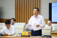 Bộ trưởng Bộ Xây dựng Trần Hồng Minh báo cáo kết quả thực hiện nhiệm vụ của ngành xây dựng. (Ảnh: Dương Giang/TTXVN)
