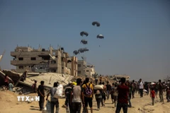 Hàng viện trợ được thả từ máy bay xuống Dải Gaza. (Ảnh: THX/TTXVN)