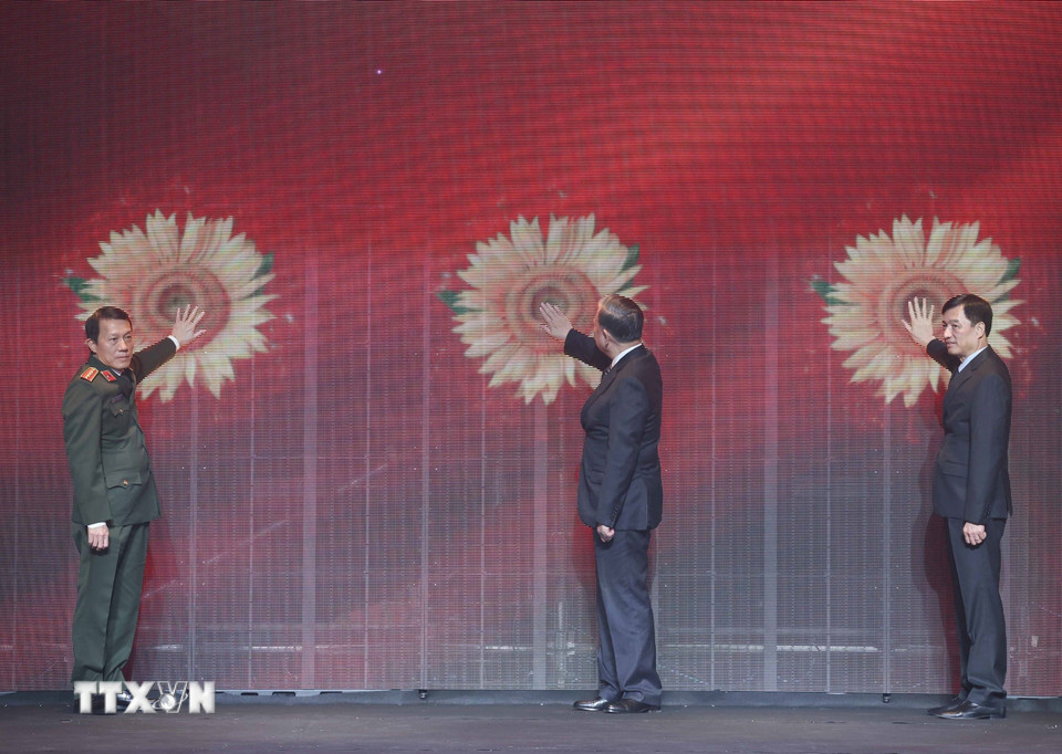 Tổng Bí thư Tô Lâm và các đại biểu thực hiện nghi thức phát động "Chiến dịch Hoa Hướng dương" do Bộ Công an phát động nhằm chia sẻ hình ảnh đẹp trên không gian mạng, vì cuộc sống bình yên. (Ảnh: Thống Nhất/TTXVN)