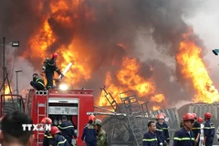 Lực lượng cảnh sát phòng cháy, chữa cháy triển khai dập lửa. (Ảnh: Quốc Dũng/TTXVN)