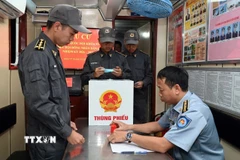 Cử tri trên tàu Cảnh sát biển 6008 thực hiện quyền và nghĩa vụ bầu cử của mình. (Ảnh: TTXVN phát)