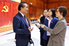 Phóng viên Báo Điện tử VietnamPlus - TTXVN tác nghiệp tại đại hội. (Ảnh: TTXVN)