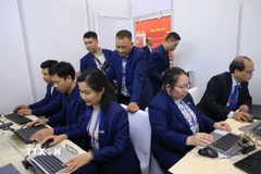 Phóng viên, biên tập viên Ban biên tập Ảnh, Thông tấn xã Việt Nam tác nghiệp tại khu vực Trung tâm báo chí của Đại hội. (Ảnh: TTXVN)