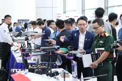 Các đại biểu tham quan gian hàng trưng bày Lễ công bố 3 Mạng lưới đổi mới sáng tạo ngành công nghệ chiến lược. (Ảnh: Lê Đông/TTXVN)