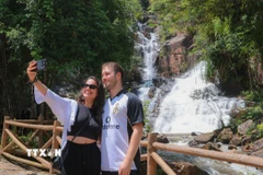 Du khách thích thú với phong cảnh thiên nhiên thác Datanla. (Ảnh: Hoàng Hiếu/TTXVN)