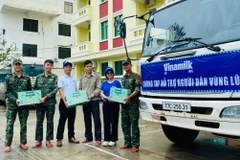 Anh Nguyễn Xuân Bình – Giám đốc Nhà máy Sữa Vinamilk Bình Định cùng cán bộ công nhân viên công ty trao tặng sản phẩm dinh dưỡng Vinamilk. (Ảnh: Vi Nam)