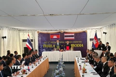 Đại tướng, Bộ trưởng Quốc phòng Thái Lan Natthaphon Narkphanit (phải, phía xa) và Đại tướng Tea Seiha, Phó Thủ tướng kiêm Bộ trưởng Quốc phòng Campuchia ký thoả thuận ngừng bắn đã được các Ban thư ký của Ủy ban Biên giới chung (GBC) hai nước thông qua về nguyên tắc, tại trạm kiểm soát biên giới ở tỉnh Chanthaburi (Thái Lan) ngày 27/12/2025. (Ảnh: THX/TTXVN)