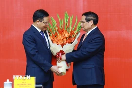 Thủ tướng Phạm Minh Chính trao Quyết định Quyền Bộ trưởng Bộ Công Thương cho đồng chí Lê Mạnh Hùng. (Ảnh: Dương Giang/TTXVN)