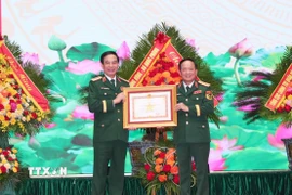 Đại tướng Trịnh Văn Quyết, Bí thư Trung ương Đảng, Ủy viên Thường vụ Quân ủy Trung ương, Chủ nhiệm Tổng cục Chính trị Quân đội Nhân dân Việt Nam trao Huân chương Quân công hạng Nhất cho Đại tướng Phan Văn Giang, Ủy viên Bộ Chính trị, Phó Bí thư Quân ủy Trung ương, Bộ trưởng Bộ Quốc phòng. (Ảnh: Trọng Đức/TTXVN)