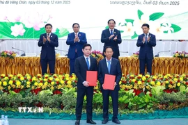 Thủ tướng Phạm Minh Chính và Thủ tướng Lào Sonexay Siphandone chứng kiến trao biên bản hợp tác giữa doanh nghiệp hai nước. (Ảnh: Dương Giang/TTXVN)