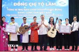 Tổng Bí thư Tô Lâm tặng quà thầy cô và học sinh Trường Phổ thông Cơ sở Nguyễn Đình Chiểu và Trường Phổ thông Cơ sở Xã Đàn. (Ảnh: Thống Nhất/TTXVN)