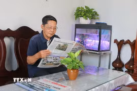 Ông Ngô Thanh Phong (sinh năm 1949, trú tại khóm Bình Thới 2, phường Bình Khánh, thành phố Long Xuyên, tỉnh An Giang), nguyên Tổng biên tập Báo An Giang vẫn thường xuyên cập nhật tin tức, các vấn đề thời sự trong nước và thế giới qua các phương tiện truyền thông, báo chí. (Ảnh: Công Mạo/TTXVN)