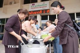 Suốt nhiều năm qua, các Phật tử chùa Phật Tích luôn duy trì bếp thiện nguyện, tự tay mang cháo tới các bệnh viện ở Lào. (Ảnh: Đỗ Bá Thành/TTXVN)