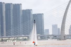 Tiết mục bay bằng ván phản lực nước - Flyboard trên sông Sài Gòn. (Ảnh: Thu Hương/ TTXVN)