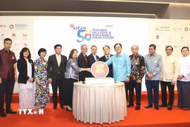 Đại diện ban tổ chức và Lãnh sự đoàn ASEAN đã cùng cắt bánh kỷ niệm 58 năm thành lập ASEAN. (Ảnh: Xuân Vịnh/TTXVN)