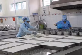 Nhân viên của bếp ăn của một trường học đảm bảo các quy chuẩn về vệ sinh an toàn thực phẩm. (Ảnh: TTXVN/Vietnam+)