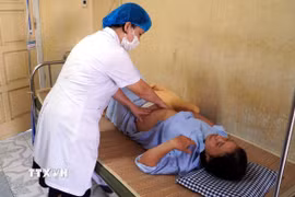 Bác sỹ khoa Phụ sản (bệnh viện Đại học Y Thái Bình) thăm khám cho bệnh nhân M.T.T (50 tuổi, trú tại tỉnh Ninh Bình). (Ảnh: Nguyễn Công Hải/TTXVN)