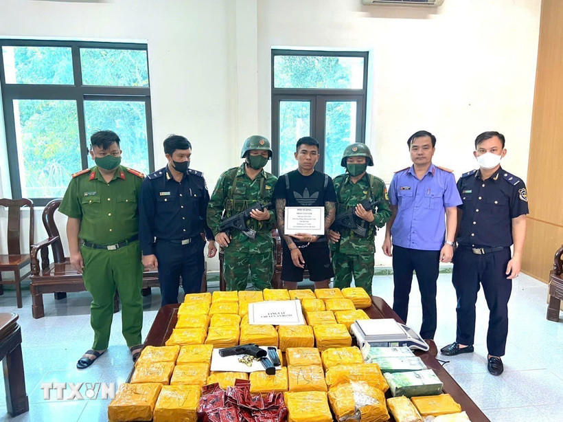 Đối tượng và tang vật vụ án. (Ảnh: TTXVN phát)