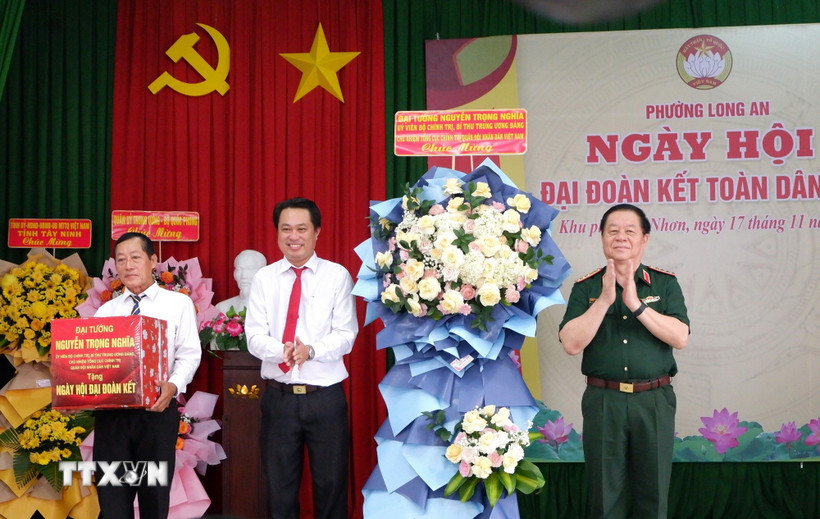 Đại tướng Nguyễn Trọng Nghĩa trao quà cho khu phố Phú Nhơn, phường Long An, tỉnh Tây Ninh. (Ảnh: Đức Hạnh/TTXVN)