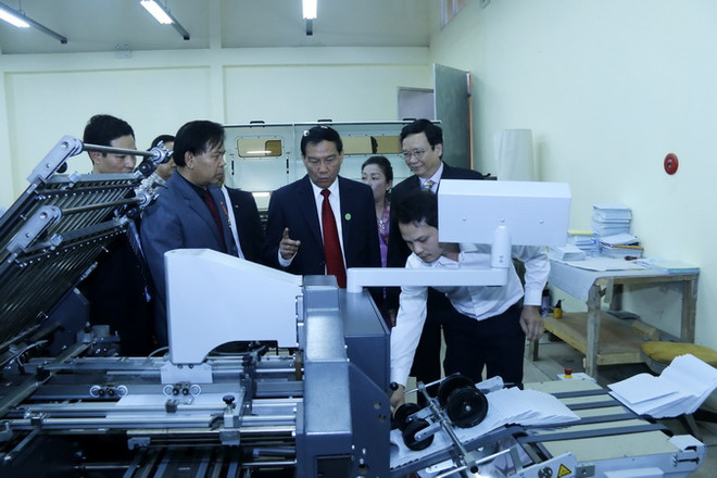 Các quan khách đang đi thăm quan Xưởng in. (Ảnh: Phạm Kiên/Vietnam+) Bàn giao Xưởng in Nhà xuất bản và phát hành sách quốc gia cho Lào ảnh 2