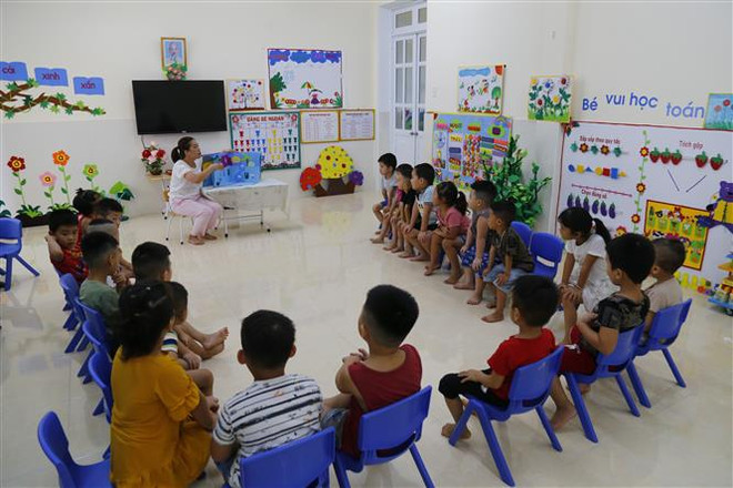 Giờ kể chuyện bằng sách 3D của một trường mầm non ở Tuyên Quang. (Ảnh: Nam Sương/TTXVN) Tránh tình trạng cơ sở giáo dục mầm non giải thể, giáo viên nghỉ việc ảnh 1