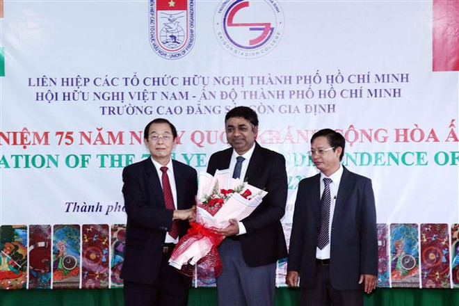 Ông Huỳnh Thành Lập (ngoài cùng bên trái), Chủ tịch Hội hữu nghị Việt Nam-Ấn Độ Thành phố Hồ Chí Minh, tặng hoa chúc mừng Tổng Lãnh sự Ấn Độ tại Thành phố Hồ Chí Minh Madan Mohan Sethi (giữa) tại buổi lễ. (Ảnh: Xuân Khu/TTXVN) TP.HCM tổ chức lễ kỷ niệm 75 năm Ngày Quốc khánh Cộng hòa Ấn Độ ảnh 1
