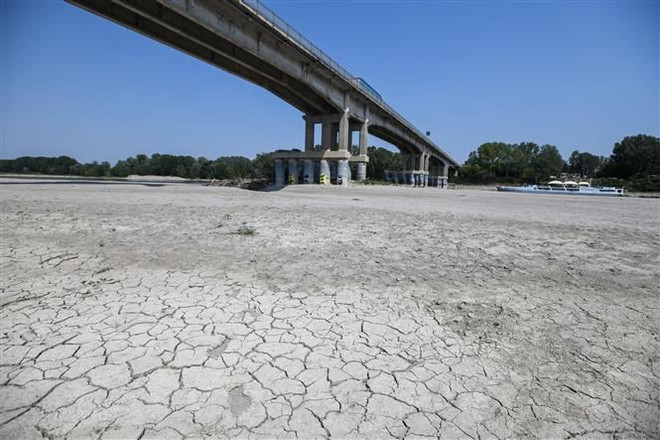 Lòng sông khô cạn do hạn hán, tại Boretto, đông bắc Parma, Italy, ngày 15/6/2022. (Ảnh: AFP/TTXVN) Trái Đất ấm dần lên, tần suất các đợt hạn ngắn gia tăng ảnh 1