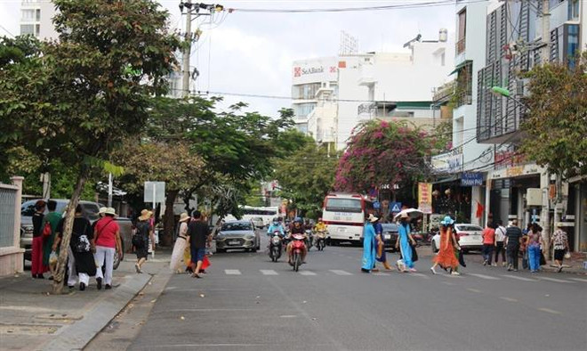 Khách du lịch bộ hành trên đường phố Nha Trang. (Ảnh: Phan Sáu/TTXVN) Đảm bảo an toàn cho du khách, Khánh Hòa khẳng định là điểm đến hấp dẫn ảnh 1