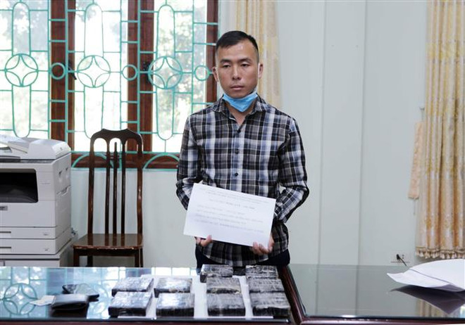 Đối tượng Sùng A Cừ, sinh năm 1999 ở bản Si Ma 2, xã Chung Chải, huyện Mường Nhé, tỉnh Điện Biên cùng tang vật là 10 bánh heroin. (Ảnh: Quý Trung/TTXVN) Lai Châu: Phá chuyên án mua bán ma túy lớn, thu giữ 10 bánh heroin ảnh 1