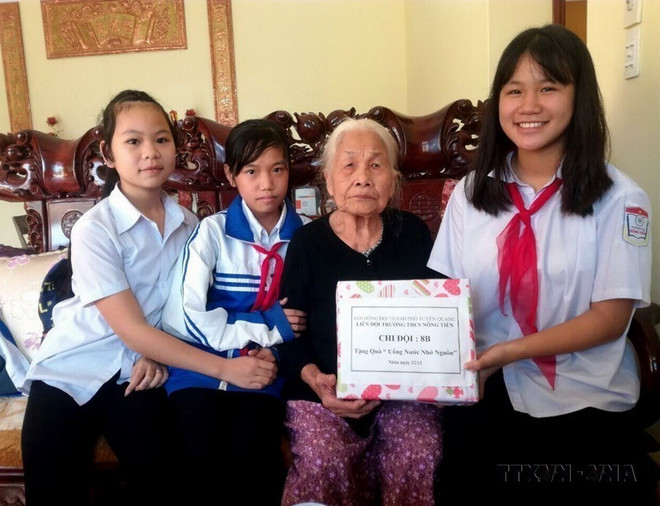 Học sinh thành phố Tuyên Quang thăm hỏi, tặng quà cho thân nhân liệt sỹ. (Ảnh: Quang Cường/TTXVN) ttxvn_liet_sy.jpg