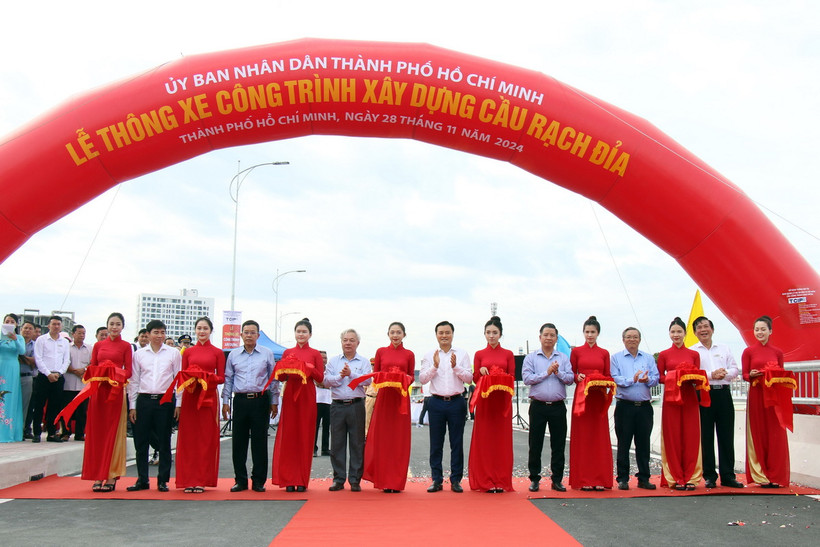 Các đại biểu thực hiện nghi thức thông xe cầu Rạch Đỉa. (Ảnh: Tiến Lực/TTXVN))