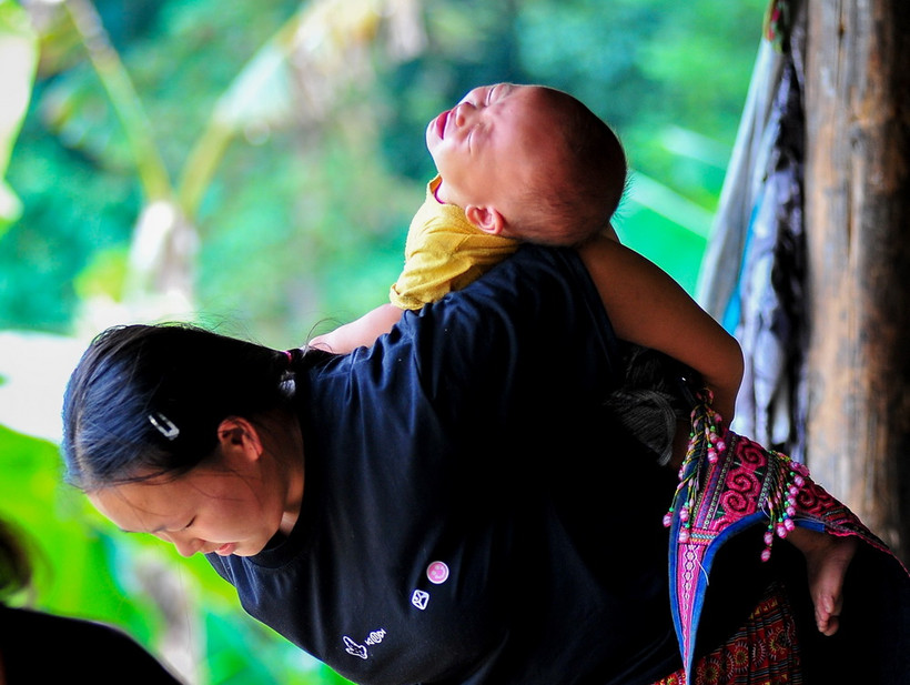 Làm mẹ khi còn trẻ, chưa có đủ kỹ năng nuôi con, chăm con, nên mỗi khi con ốm đau, quấy khóc, thực sự vất vả. (Ảnh: Nam Thái/TTXVN)