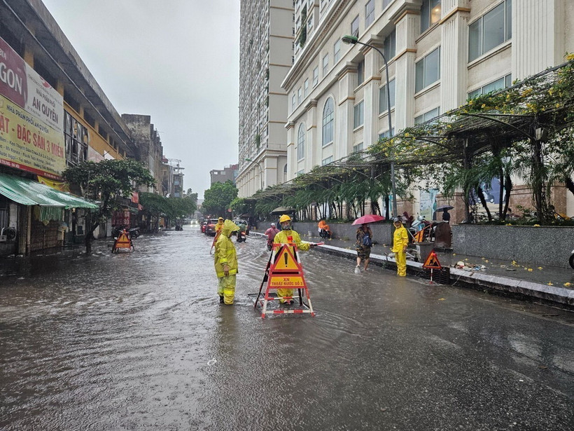 Công nhân Công ty Thoát nước Hà Nội ứng trực đảm bảo tiêu thoát khi mưa ngập. Ảnh: TTXVN phát