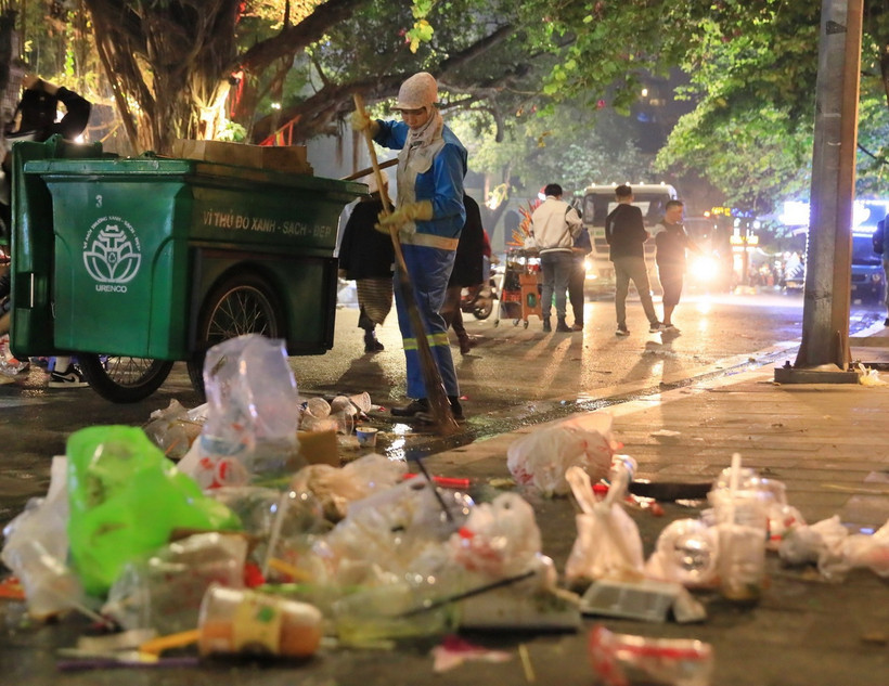 Lượng lớn rác và túi ni lông đang được công nhân của công ty Công ty TNHH MTV Môi trường Đô thị Hà Nội thu gom, xử lý. (Ảnh: Hoàng Hiếu/ TTXVN)