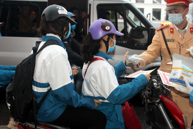 Cảnh sát Giao thông phát khẩu trang miễn phí cho người tham gia giao thông. (Ảnh: Việt Hùng/TTXVN)