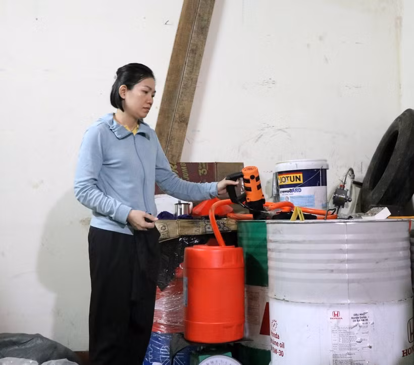 Đối tượng Quách Thị Thu Hồng thực hiện lại hành vi san chiết nhớt giả. (Ảnh: Xuân Triệu/TTXVN)