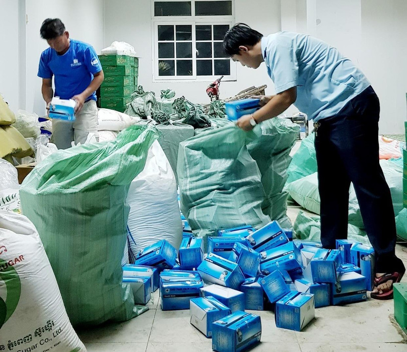 Cán bộ hải quan Chi cục Hải quan cửa khẩu quốc tế Vĩnh Xương, tỉnh An Giang, kiểm đếm số khẩu trang y tế mới thu giữ. (Ảnh: Công Mạo/TTXVN)