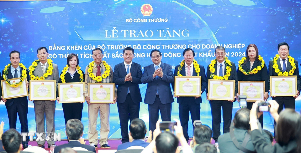 Thủ tướng Phạm Minh Chính và Bộ trưởng Bộ Công Thương Nguyễn Hồng Diên trao hoa và khen thưởng cho các doanh nghiệp có thành tích xuất sắc. (Ảnh: Dương Giang/TTXVN)